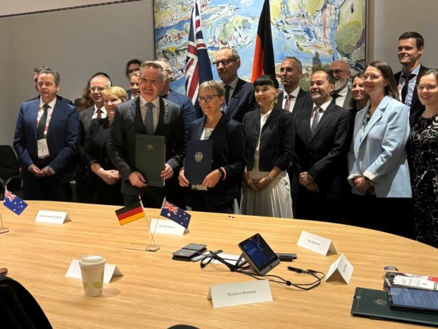 Australian and German government officials sign the newH2Global agreement in Brisbane.